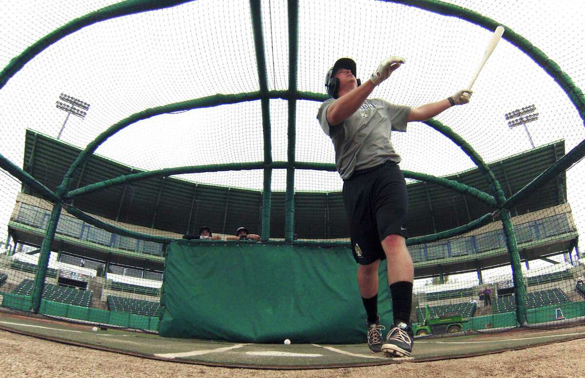 Lee Orr of the San Antonio Missions watching the ball fly as he hits in the batting cage during the first workout for the team at Wolff Stadium on Tuesday, April 1, 2014.