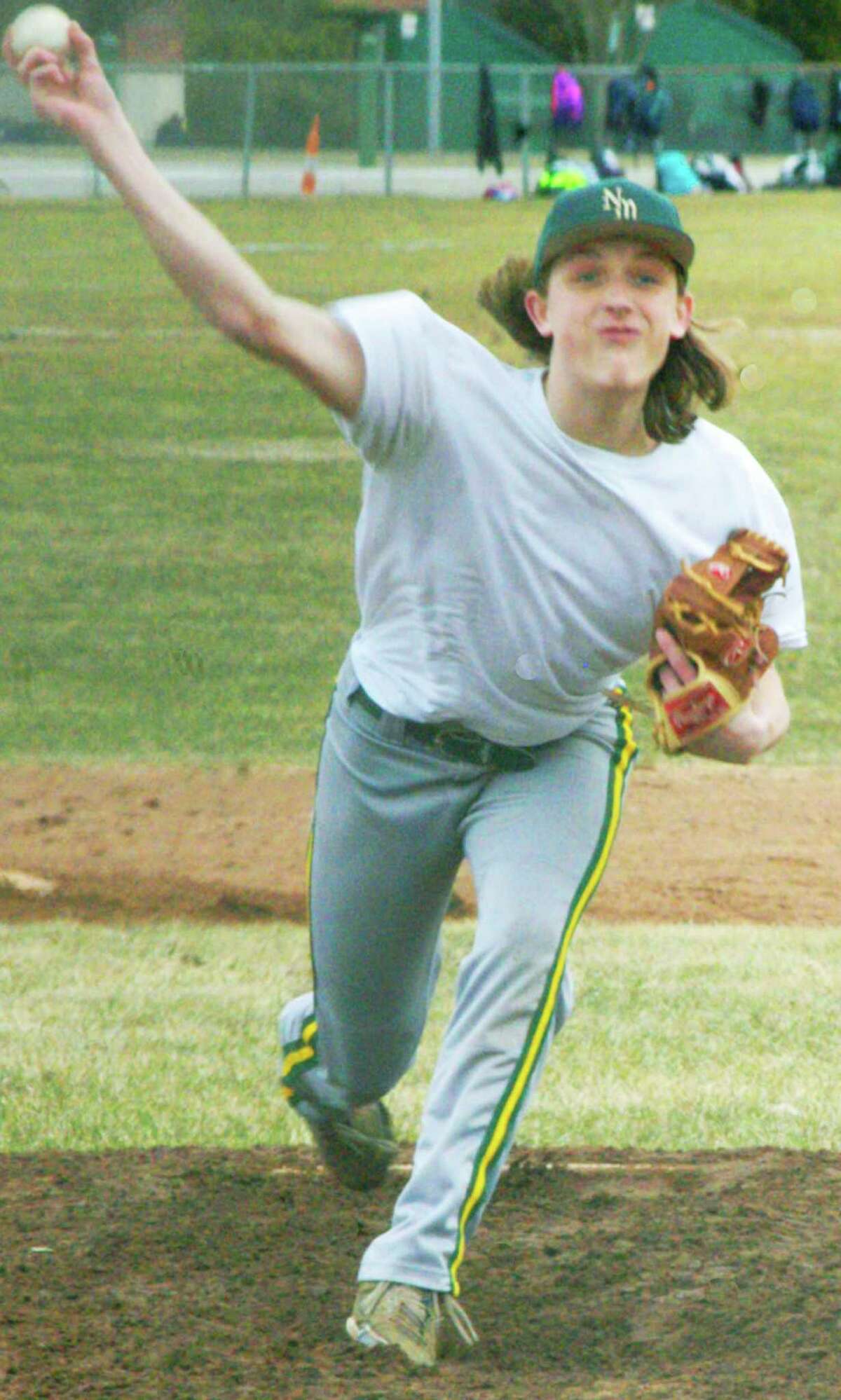 Play ball! Warmer temperatures and the reality that opening day was just a week away sparked a surge in energy for spring sports teams prepping this week at New Milford and Shepaug Valley High School for their 2014 seasons. Above, pitching hopeful Cooper Knight, minus his Green Wave jersey but otherwise very much into the task at hand, fires a pitch during a scrimmage against Sacred Heart of Waterbury at NMHS. Nine New Milford High varsity teams and seven more at Shepaug will compete for respective laurels in the South-West Conference and Berkshire League. For previews of all the teams, including rosters, schedule and plenty of photos, see the April 11 and 18 editions of the Spectrum and visit www.newmilfordspectrum.com.