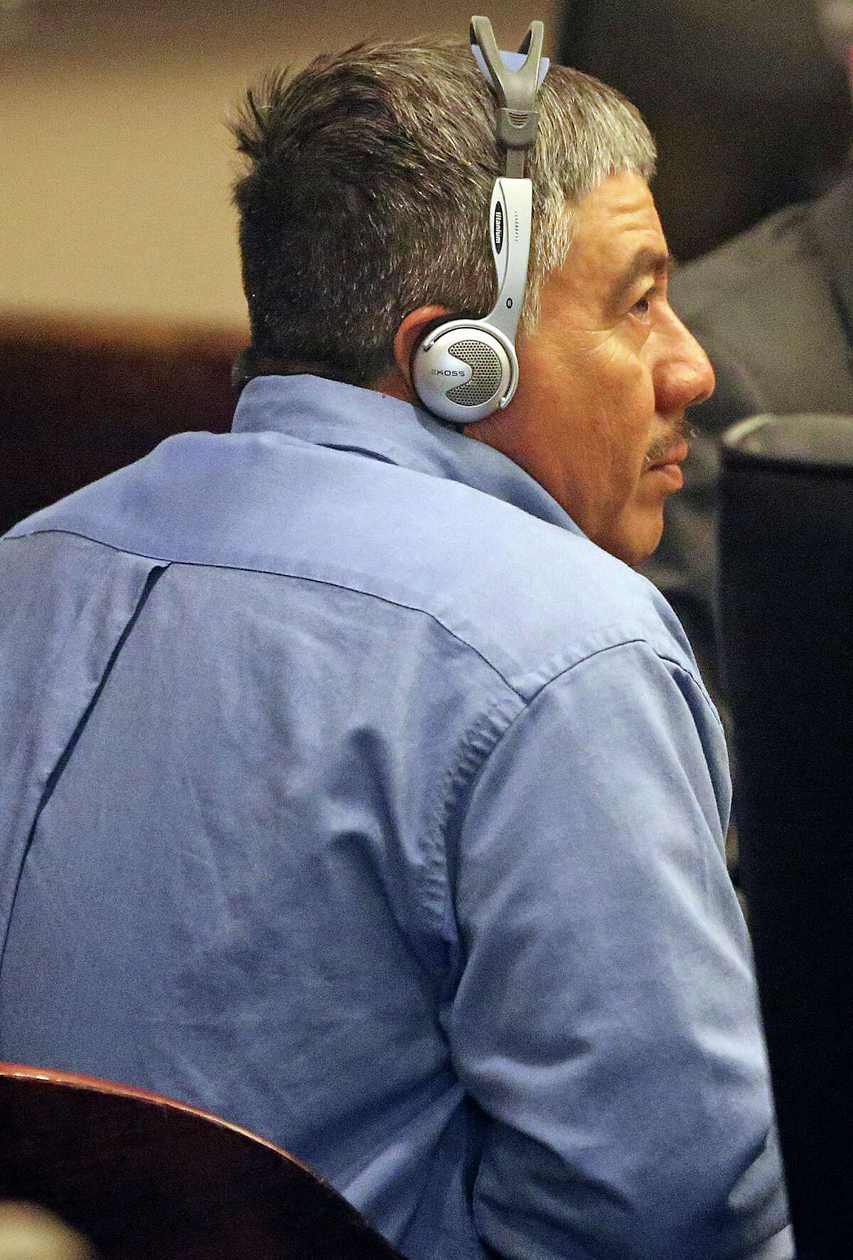 Paulino Flores, accused of murder, listens to language interpretation as he appears in the 144thth District Court at the beginning of proceedings of his trial on April 2, 2014.