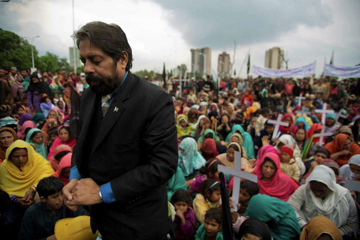Residents of Islamabad's slums pray during a protest against the demolition of their localities, in Pakistan, Wednesday, April 2, 2014. Pakistani authorities plan to demolish these slums, mostly occupied by Christians and people displaced in tribal areas and neighboring Afghanistan, saying it poses a security threat to the already vulnerable capital. (AP Photo/B.K. Bangash)
