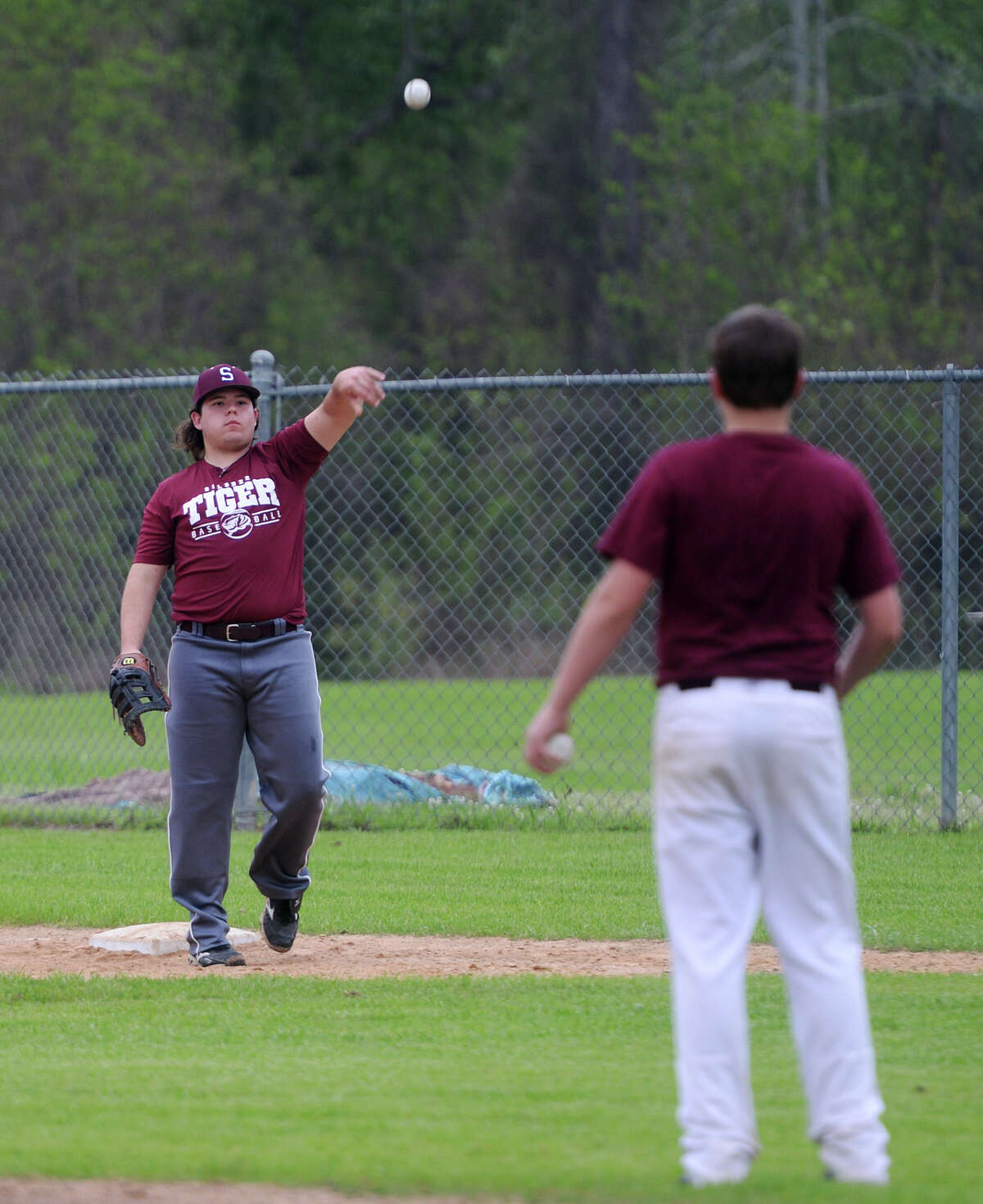 Brayden Griffin throws toward the pitcher's mound from first base during practice Thursday. The Silsbee High School baseball team practiced Thursday afternoon. Photo taken Thursday, 4/3/14 Jake Daniels/@JakeD_in_SETX