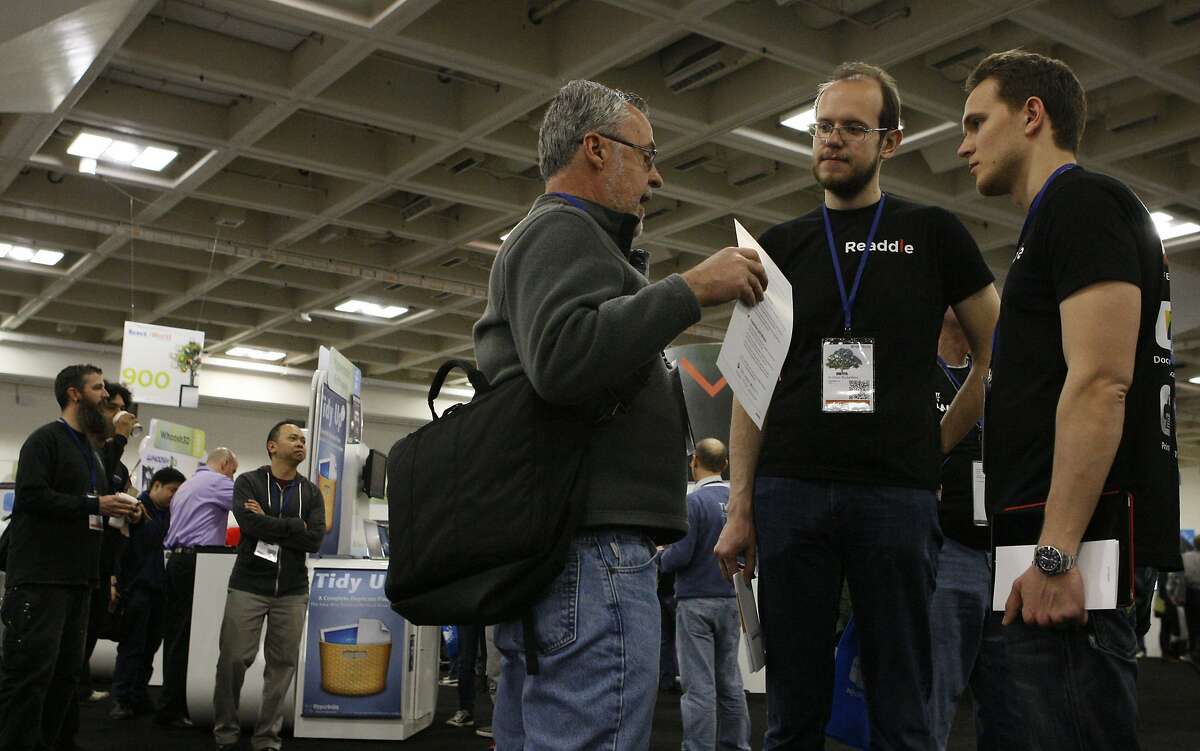 Mike Stearns (left), Andrian Budantsov (center) and Denys Zhadanov (right) discuss mobile apps during Macworld/iWorld at the Moscone Center on March 28, 2014 in San Francisco, Calif. Budantsov and Zhadanov work for Readdle, an app company based in Odessa, Ukraine, a country currently in the midst of turmoil.