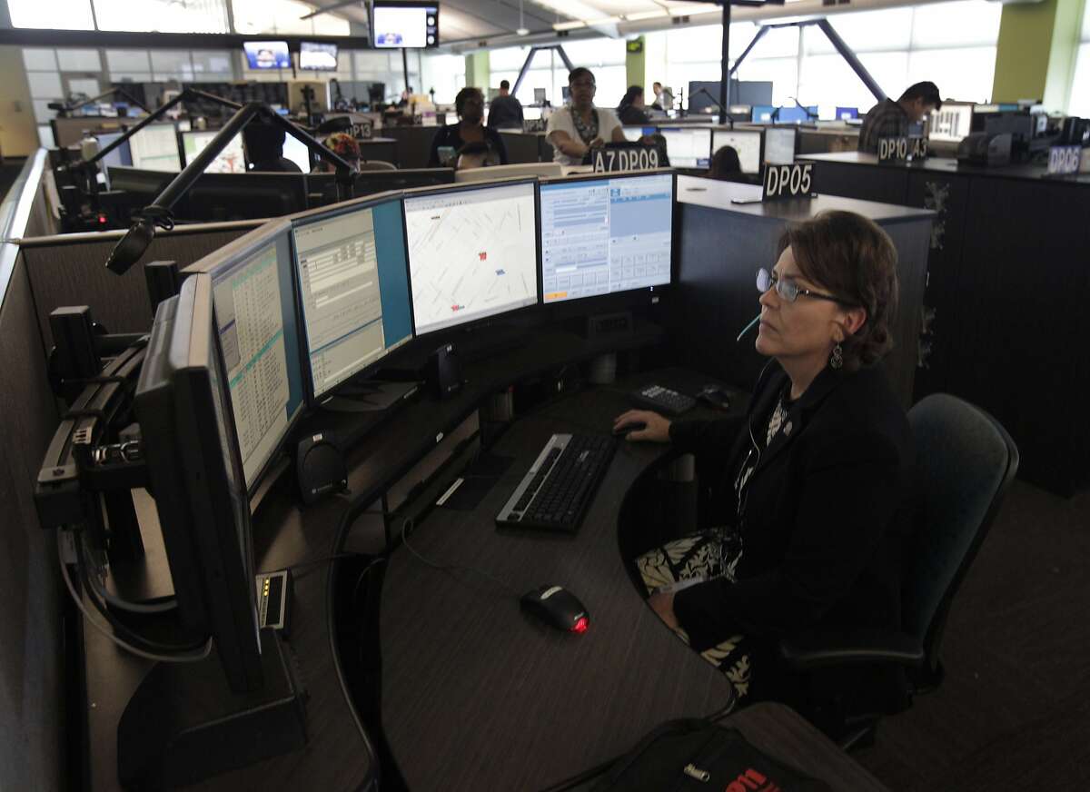 Veteran emergency dispatcher Lisa Hoffmann fields a 911 call on her final day of work in San Francisco, Calif. on Friday, March 21, 2014. Hoffmann is retiring as a supervisor for the city's Department of Emergency Management after a 32-year career.