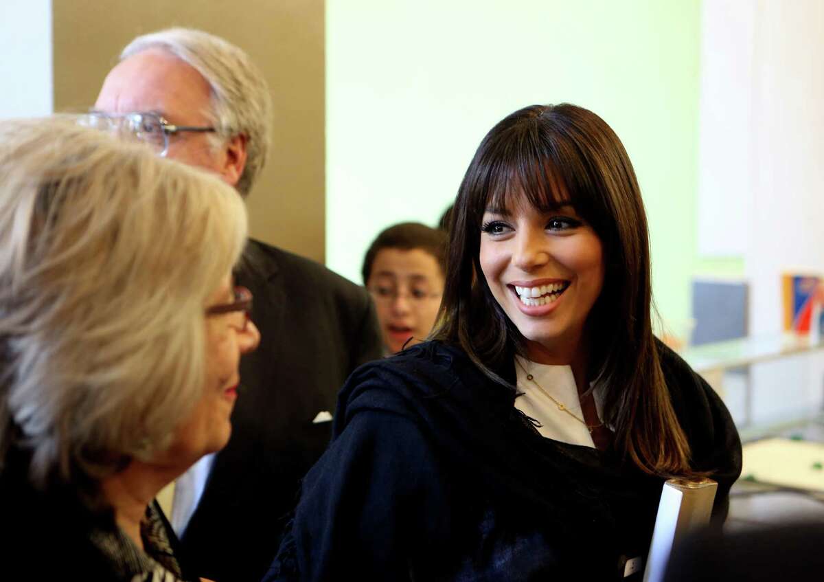 Eva Longoria waits to order at the Dairy Queen in Rivercenter mall after speaking at the Accion 20th anniversary kick off luncheon on Friday April 4, 2014. Longoria, Howard Buffett, son of billionaire Warren Buffett, spoke at the luncheon at the Marriott Rivercenter Hotel. The Eva Longoria Foundation and the Howard G. Buffett Foundation have joined with Accion Texas to create a new small business loan fund for Latina entrepreneurs in Texas. Since 2013 the fund has made 58 micro loans totaling more than $500,000.