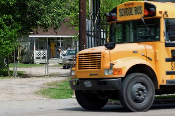 A school bus passes by a home where high-risk sex offenders had been moved to on the 9300 block of W. Montgomery Road in the Acres Homes neighborhood Friday, April 4, 2014, in Houston. 
The high-risk offenders had been moved out of the halfway house because they were taking up beds there that were needed for low-risk regular felons who were exiting prison on parole, for treatment and rehabilitation programs.