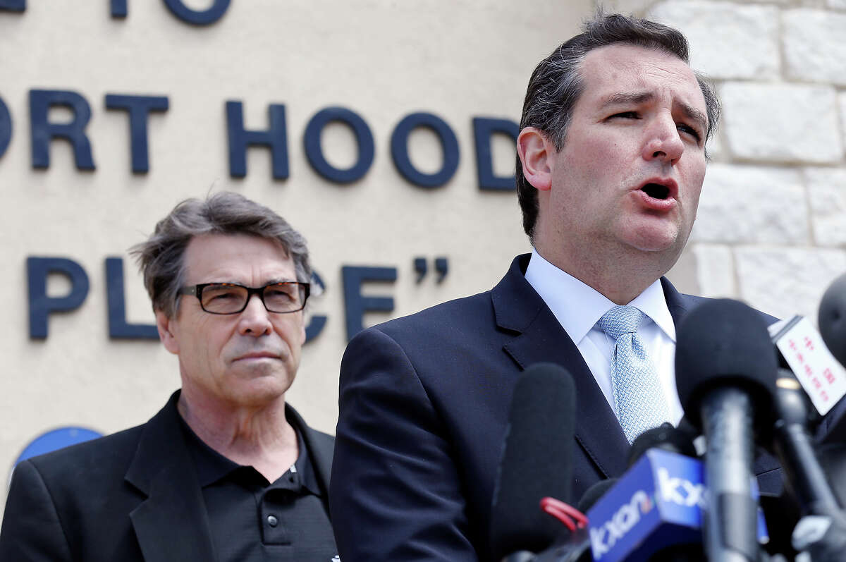 U.S. Sen. Ted Cruz (right) speaks as Gov. Rick Perry and other local officials listen during a press conference held at Fort Hood's main gate Friday April 4, 2014 in Fort Hood, Texas. Iraq war veteran Ivan Lopez opened fire Wednesday afternoon, killing three soldiers and wounding 16 before killing himself as he was confronted by a military policewoman.