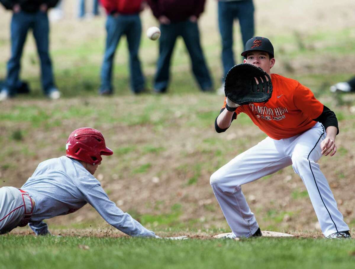 Stamford high school first baseman James Gromberg taking a throw from the pitcher during a pitchout during a baseball scrimage against Greenwich high school played at Julian Curtiss school, Greenwich, CT on Saturday, April, 5th, 2014.