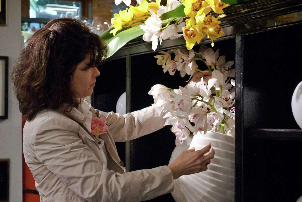 Nielsen's Florist and Garden Shop in Darien held a flower show to celebrate their 70 year anniversary of being in business from April 4-6. Dana Burwell, from New Canaan, adjusts one of the displays.