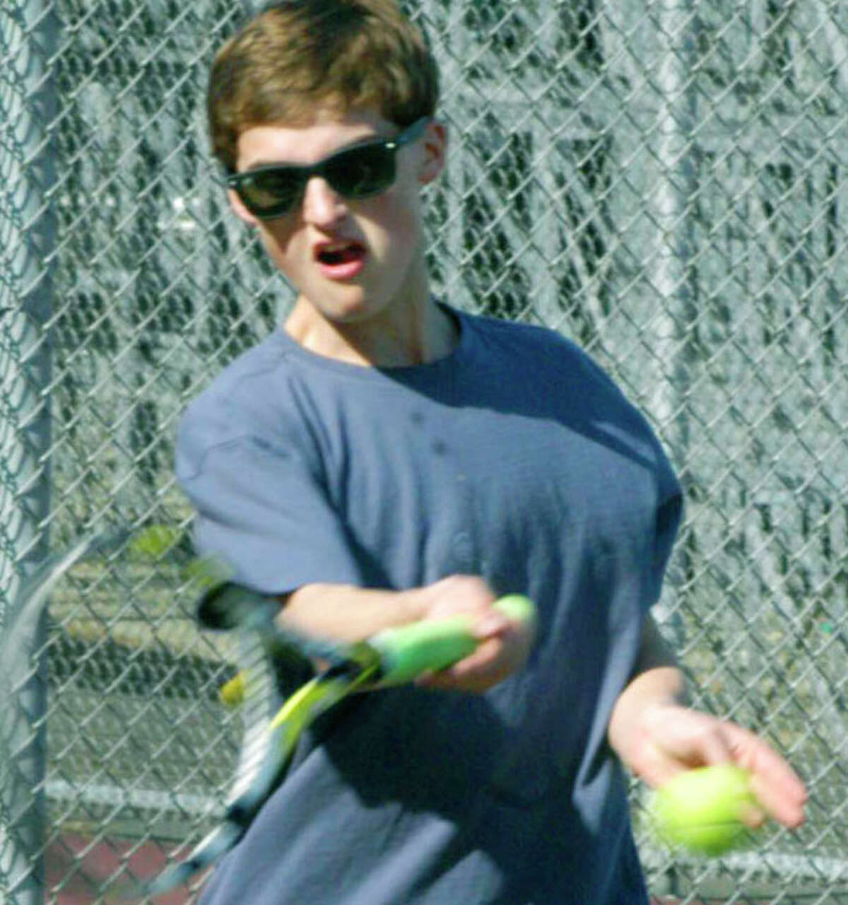 Hunter Berrett of the Green Wave lashes a forehand return during pre-season for New Milford High School boys' tennis. April 2014