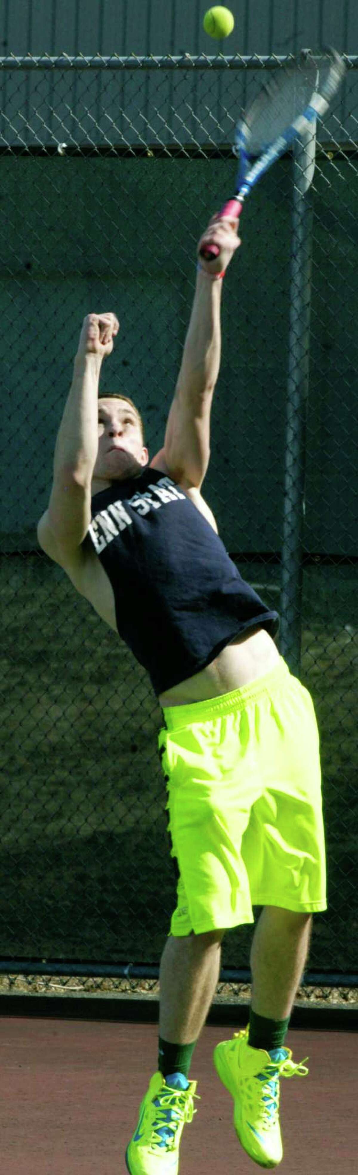 Nick Eherts of the Green Wave works on his serve for New Milford High School boys' tennis. April 2014