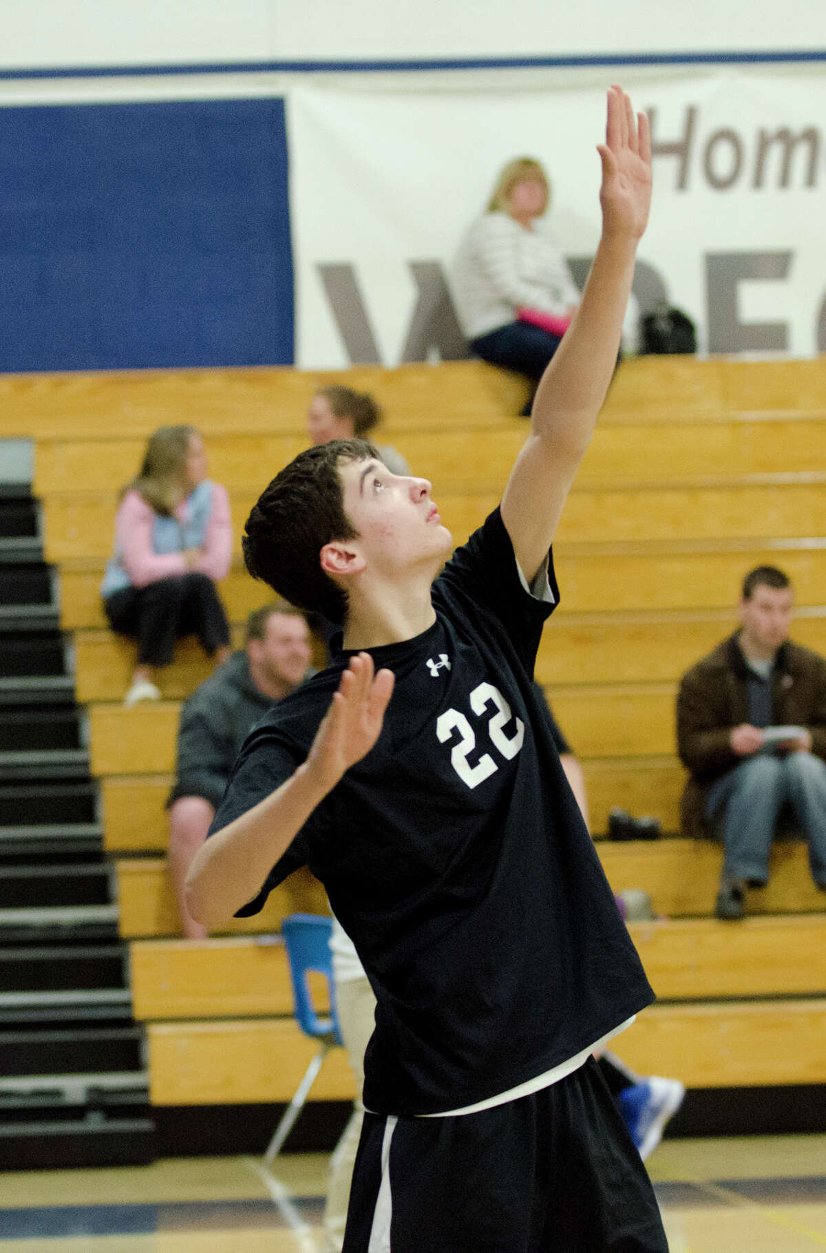 Fairfield Ludlowe/Warde co-op's Tim Beradino (22) serves the ball during the boys volleyball game against Staples at Staples High School in Westport on Monday, Apr. 15, 2013.