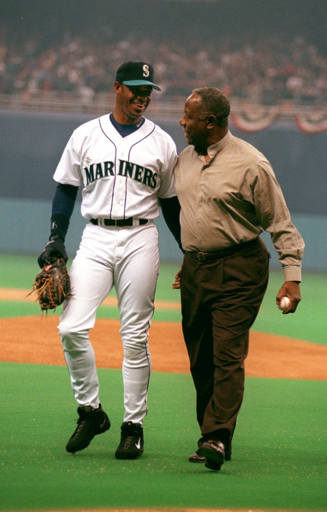 Former Seattle Mariners players Edgar Martinez, facing, greets Ken Griffey  Jr. (24) as they prepare to throw out ceremonial first pitches during the  MLB All-Star baseball game in Seattle, Tuesday, July 11