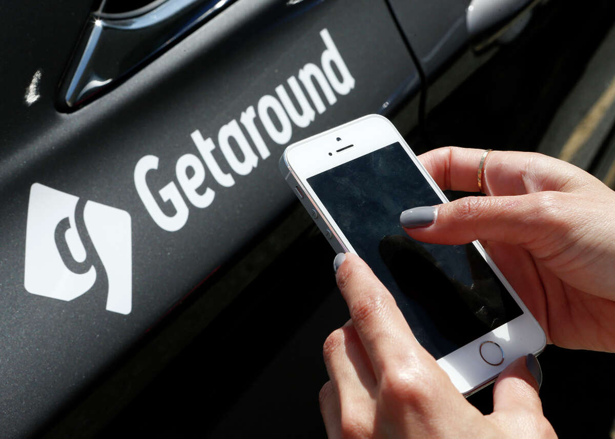 Getaround employee Charlene Foote demonstrates how to rent a car through the company’s app last year.