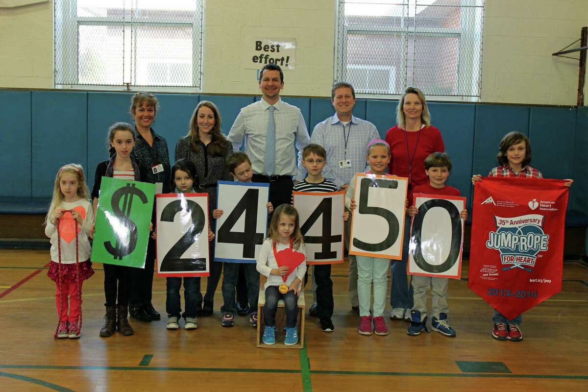 Royle Elementary School in Darien set a new record for funds raised during the annual Jump Rope for Heart. Seated, Tanner Shanley, the school's top fundraiser. Middle row from left, Emma St. Jean, Abby St. Jean, Emma Van Loan, Connor Hardy, Jake Blyth, Molly McGuckin, Briggs McGuckin and Andrew Marcula. Top row, Susan McGrath, of the American Heart Association; Vice Principal Natasha Torre; Principal Keith Margolus; Physical Education Director Chris Manfredonia; and PE teacher Jill Cardamone.