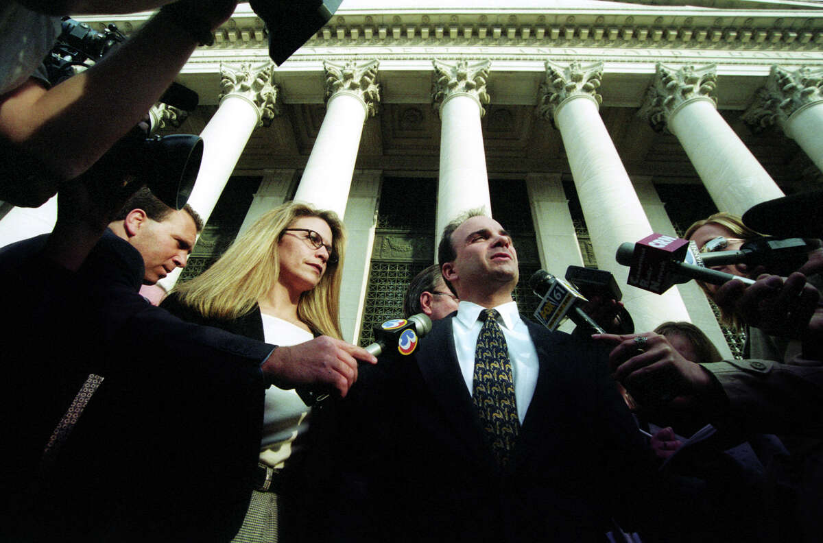 Mayor Joseph Ganim with his wife Jennifer surrounded by media in front of U.S. District Court in New Haven, Conn. on March 18th, 2003. The next day, Ganim was found guilty on 16 of 21 federal corruption charges.