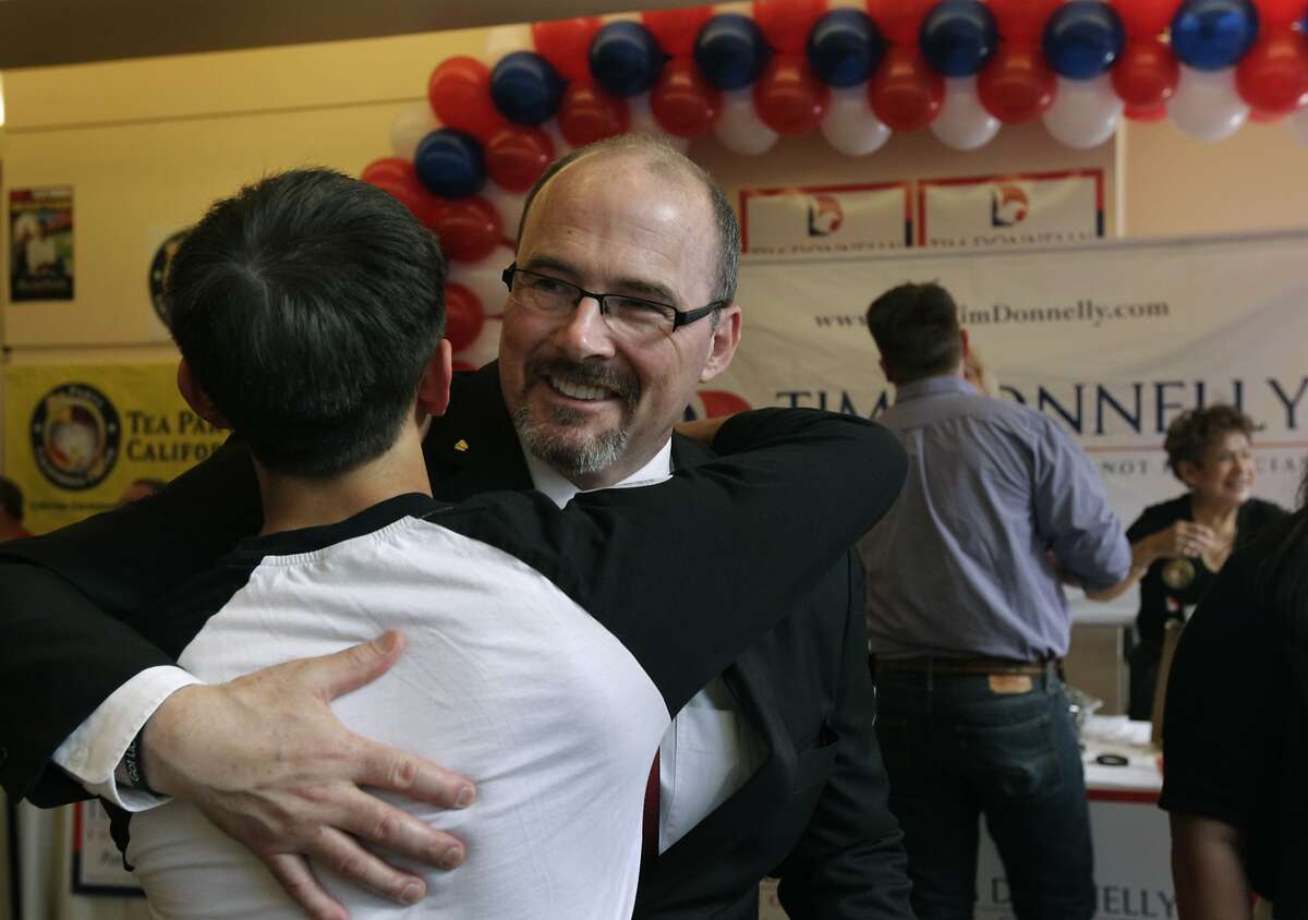 Gubernatorial candidate Tim Donnelly hugs his son Daniel at the California Republican Party spring convention in Burlingame, Calif. on Saturday, March 15, 2014.