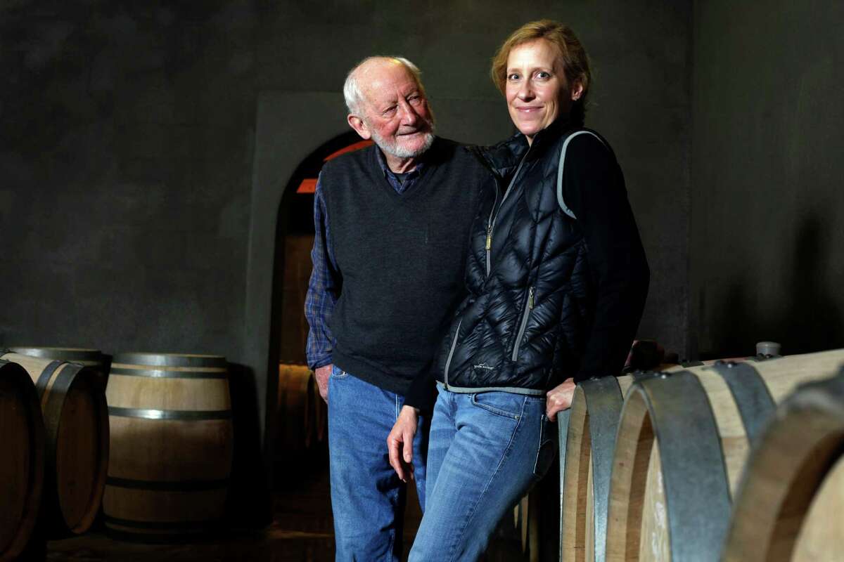 Philip Togni and his daughter Lisa stands among their family wine barrels at the Philip Togni Winery in St. Helena.