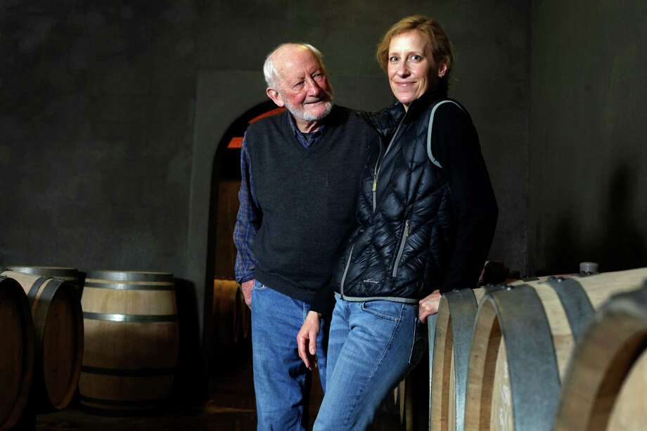 Philip Togni and his daughter Lisa stands among their family wine barrels at the Philip Togni Winery in St. Helena. Photo: Lacy Atkins / The Chronicle / ONLINE_YES