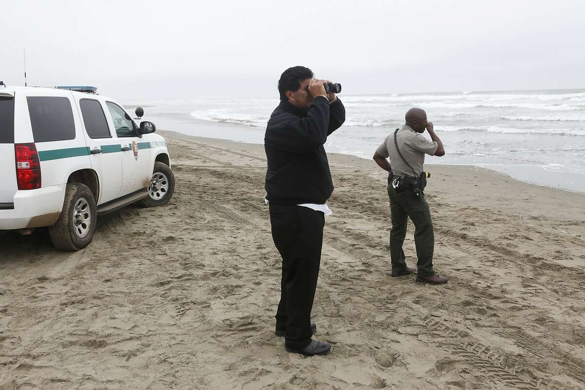 Emergency workers search for a missing person at Ocean Beach near Lincoln Way on Wednesday, April 9, 2014 in San Francisco, Calif.