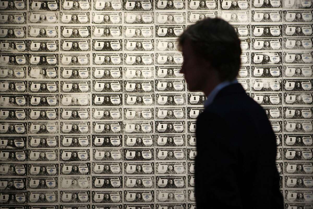 FILE - In this Oct. 12, 2009 file photo, a visitor stands in front of a painting "200 One Dollar Bills," by Andy Warhol on display at the auction house in London. Warhol painting called "200 One Dollar Bills" has sold at auction for $43.8 million, ($29.3 million euro) more than three times its highest presale estimate of $12 million. (AP Photo/Sang Tan, File)