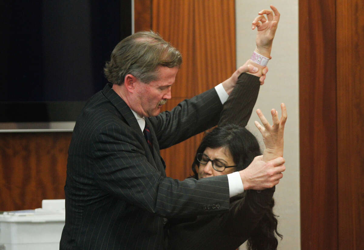 Defense attorney Jack Carroll, left reenacts the night of the crime with convicted killer Ana Trujillo during the punishment phase of her trial Thursday, April 10, 2014, in Houston. Trujillo was convicted in the brutal 2013 slaying of her boyfriend, Alf Stefan Andersson, using a 5-inch stiletto shoe. ( Brett Coomer / Houston Chronicle )