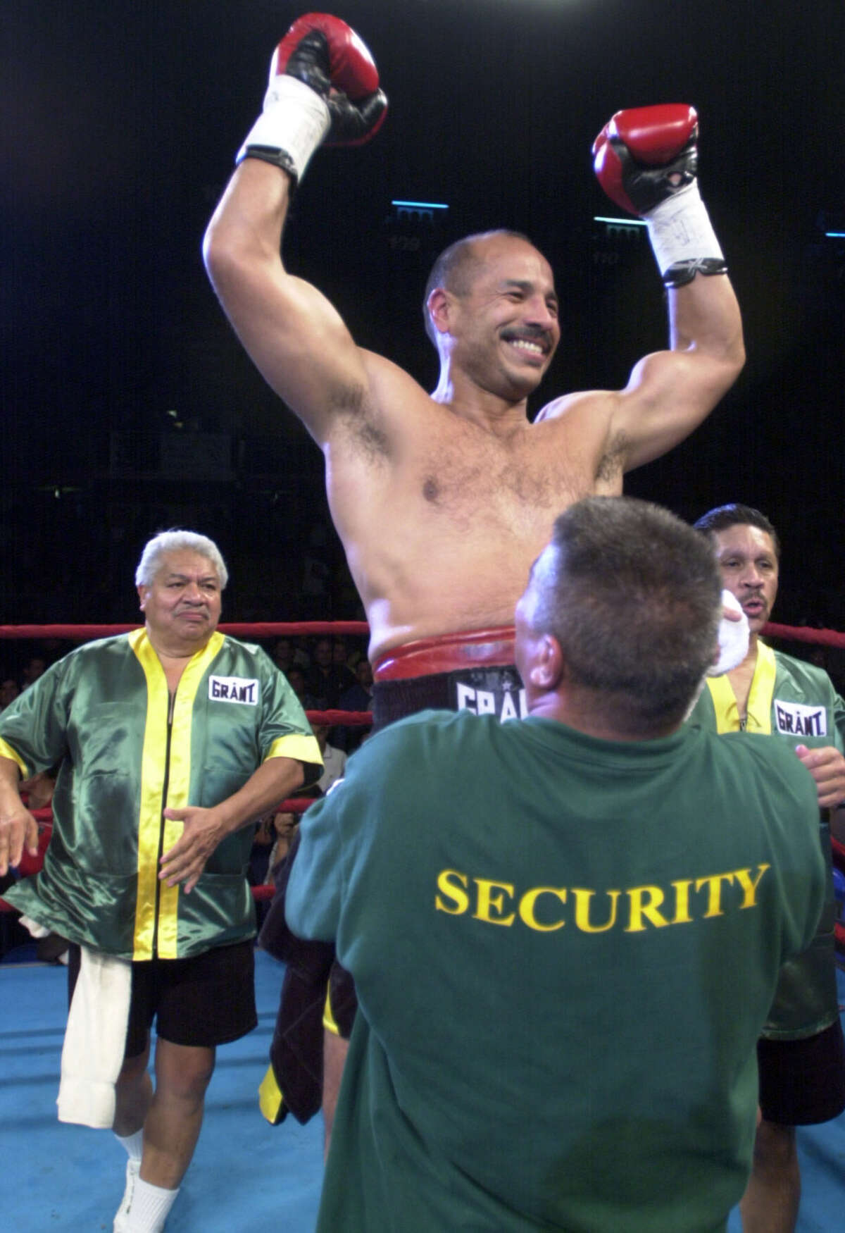 Tony Ayala, Jr. celebrates his victory in his last fight April 15, 2000. Tony Ayala, Sr. stands in the background at left.