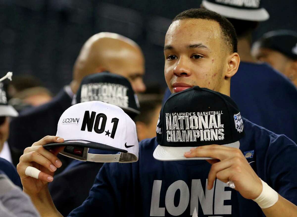 ARLINGTON, TX - APRIL 07: Shabazz Napier #13 of the Connecticut Huskies celebrates on the court after defeating the Kentucky Wildcats 60-54 in the NCAA Men's Final Four Championship at AT&T Stadium on April 7, 2014 in Arlington, Texas.