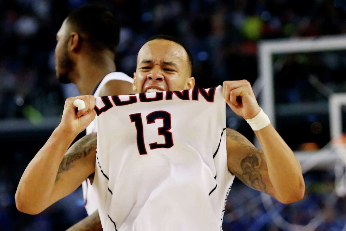ARLINGTON, TX - APRIL 07: Shabazz Napier #13 of the Connecticut Huskies celebrates on the court after defeating the Kentucky Wildcats 60-54 in the NCAA Men's Final Four Championship at AT&T Stadium on April 7, 2014 in Arlington, Texas.