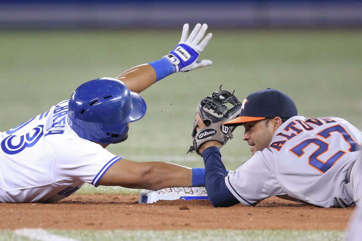 The Blue Jays' Melky Cabrera, left, beats the Astros' Jose Altuve to second base after drilling a double in the eighth inning Thursday night.