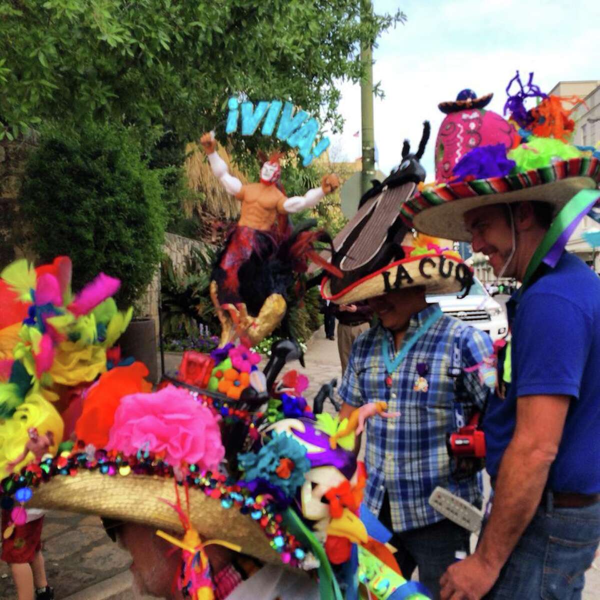 Big hat wearers like David L. Durbin (crouched) and his buddies were hounded by the paparazzi at Fiesta Fiesta.