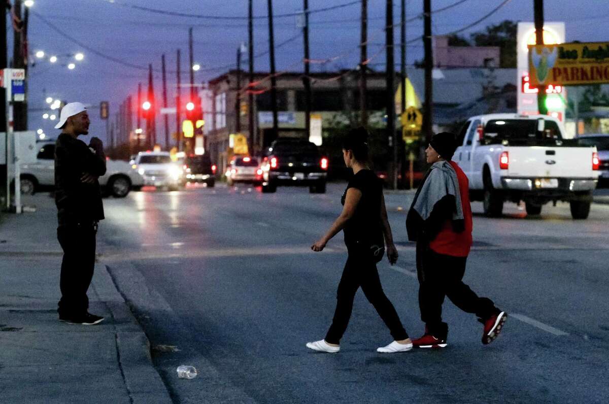 Pedestrians cross the 200 block of N. Zarzamora at dusk. A reader reminds us that pedestrian safety is a two-way street.