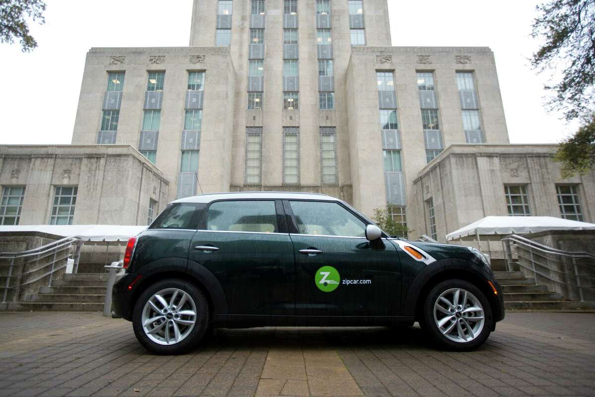A Zipcar is parked on front of the Houston City Hall, Wednesday, March 26, 2014 as the company introduces the car-sharing service to Houston. Cars are available by the hour or by the day to residents, students, businesses and visitors. ( Marie D. De Jesus / Houston Chronicle )