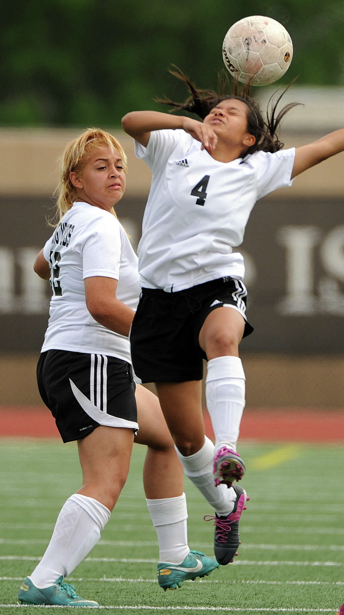 Spring Woods' Leonor Zambrano (4) heads the ball ﻿during the first half.