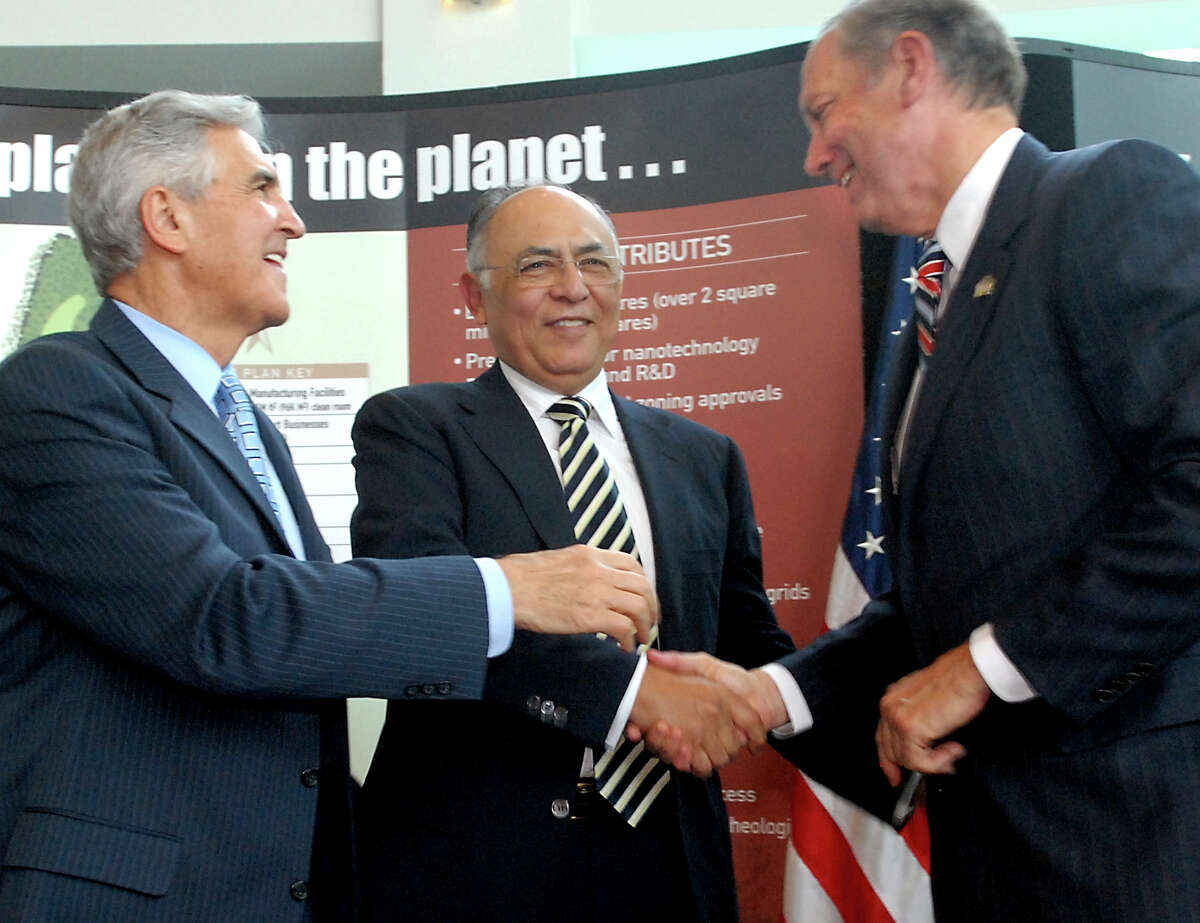 Hector Ruiz, CEO and chairman of Advanced Micro Devices Inc. (AMD), center, shakes hands with Gov. George Pataki, right, and Sen. Joseph Bruno, left, during a news conference on Friday, June 23, 2006, at CESTM in Albany, N.Y. (Cindy Schultz /Times Union archive)