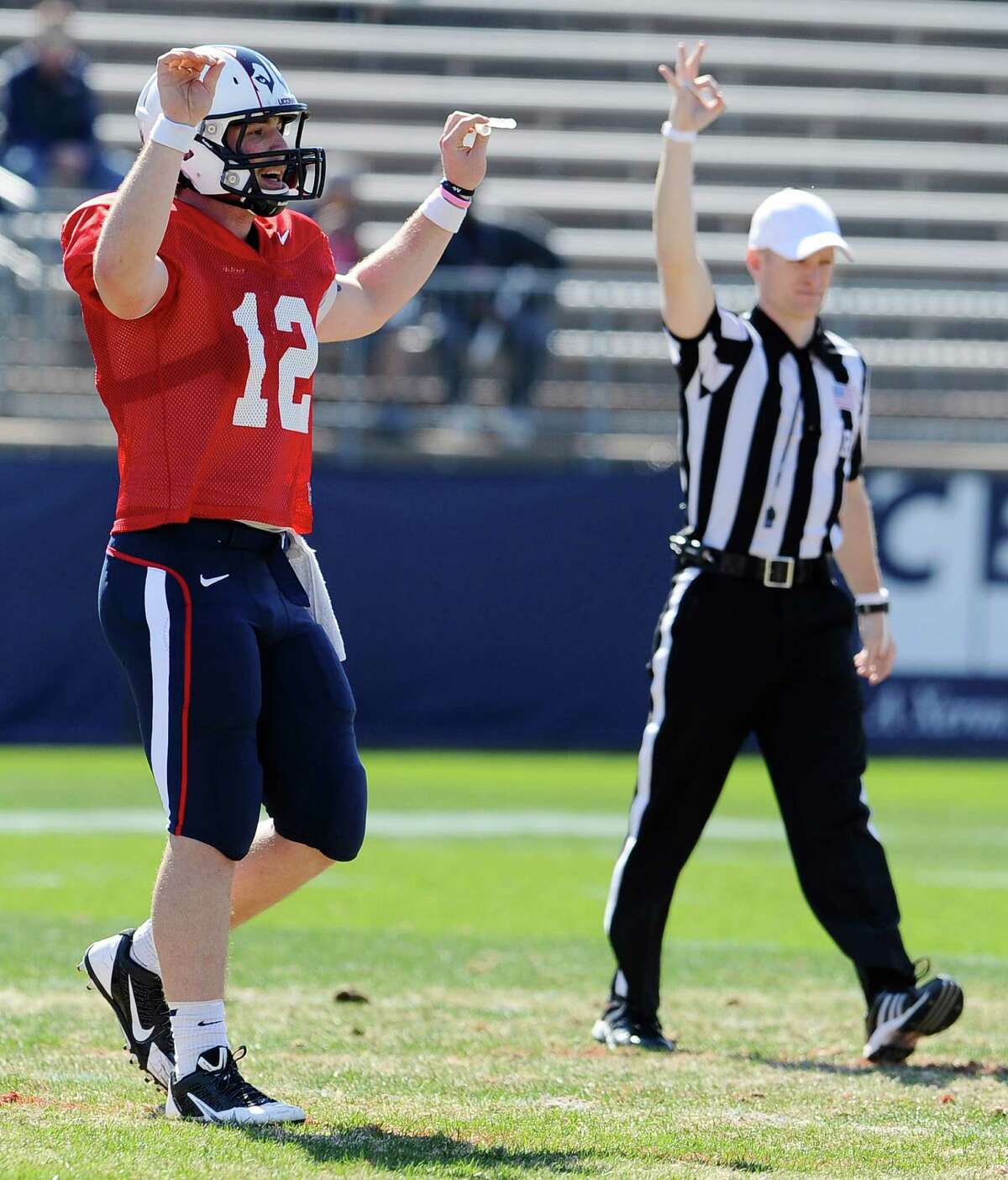 Connecticut quarterback Casey Cochran, left, gestures to a coach during the half of UConn's Blue-White spring NCAA college football game at Rentschler Field, Saturday, April 12, 2014, in East Hartford, Conn. (AP Photo/Jessica Hill)