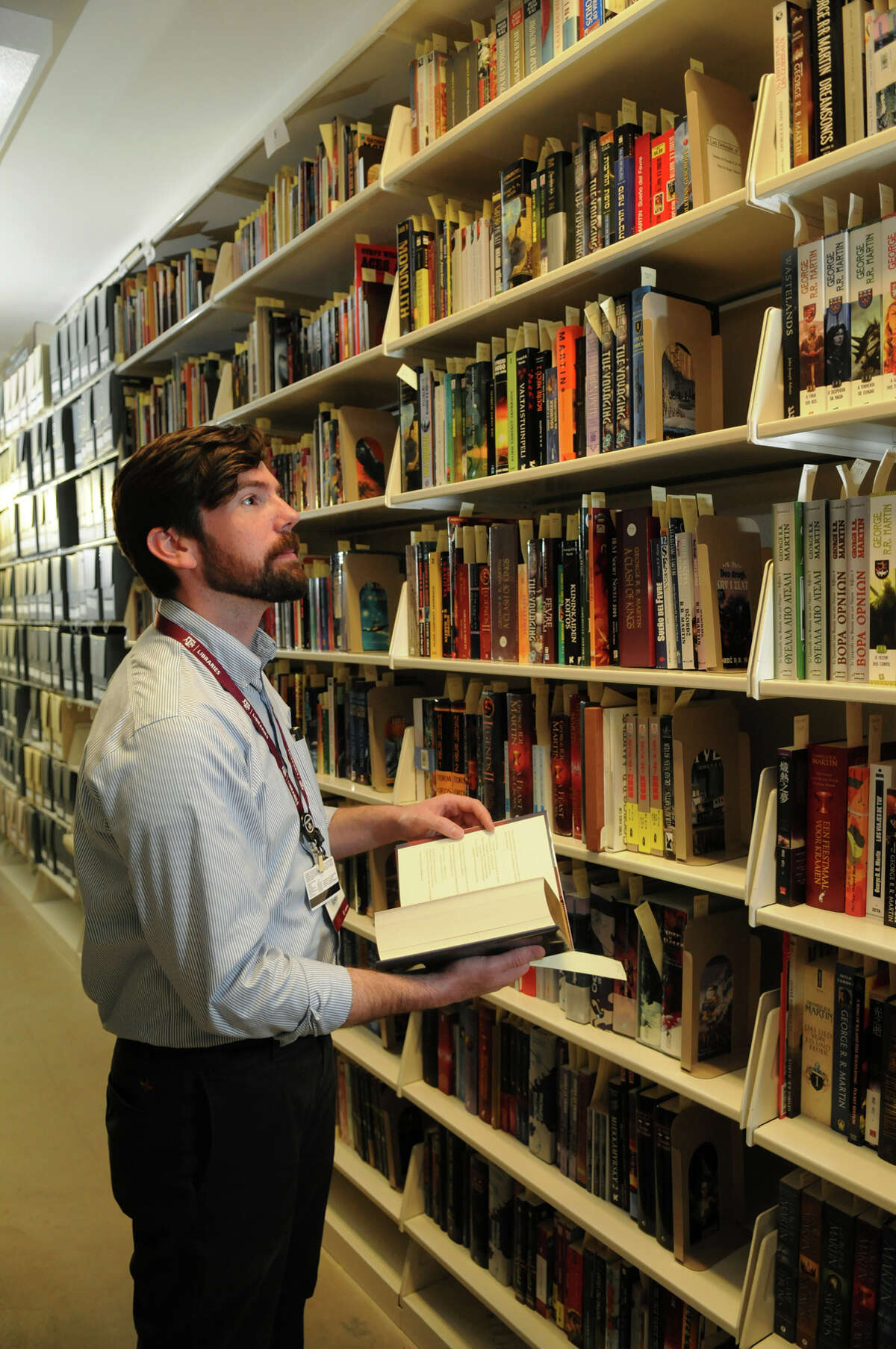 Kevin O'Sullivan, a curator at the Cushing Memorial Library and Archives, browses "The Wall," which houses works by George R.R. Martin.
