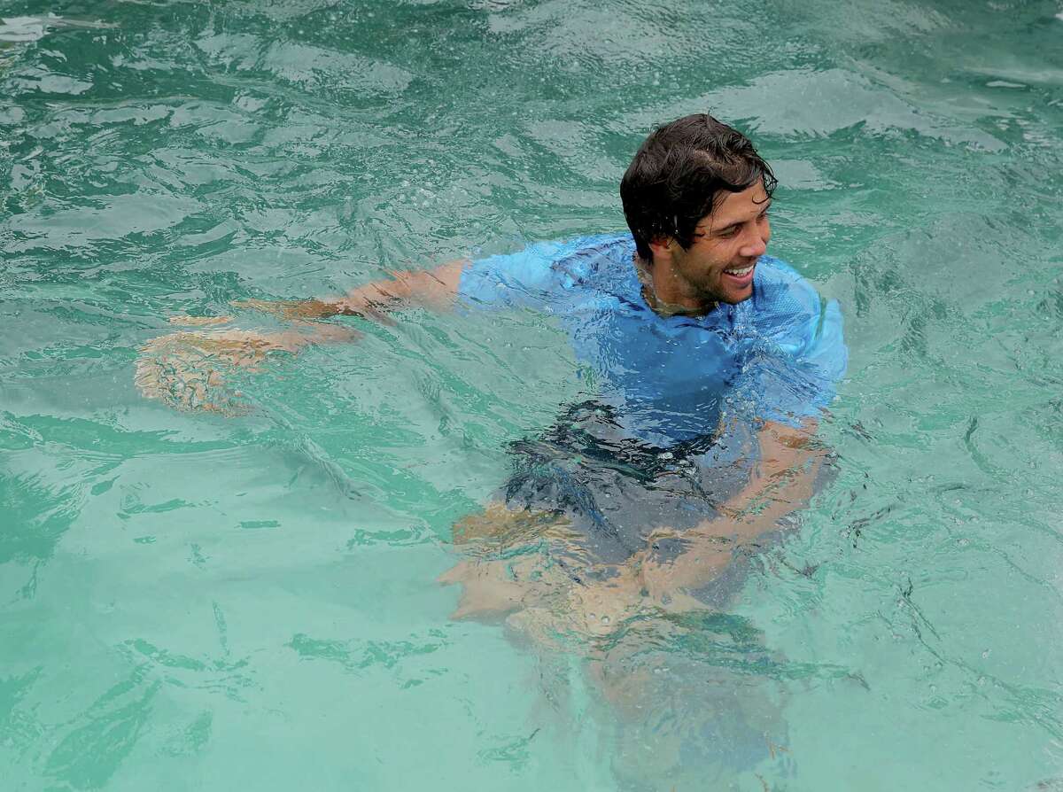 Fernando Verdasco (ESP) jumps in the River Oaks Country Club Pool after defeating Nicolas Almagro (ESP) ) 6-3, 76 in the singles finals on April 13, 2014 at the U.S. Men's Clay Court Championship at River Oaks in Houston, TX. .