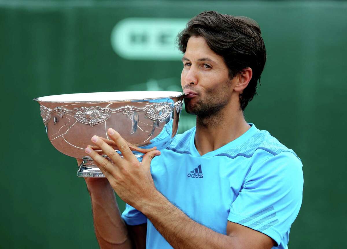 Fernando Verdasco (ESP) kisses the tropy after defeating Nicolas Almagro (ESP) ) 6-3, 76 in the singles finals on April 13, 2014 at the U.S. Men's Clay Court Championship at River Oaks in Houston, TX. .
