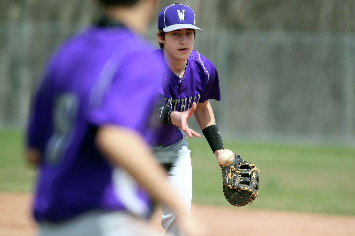 Westhill High School first baseman Matt Gorey makes a toss to a teammate for an out during FCIAC baseball action in Stamford, Conn on Monday, April 14, 2014. Westhill, led by timely hitting, won the well played game, 5-4.