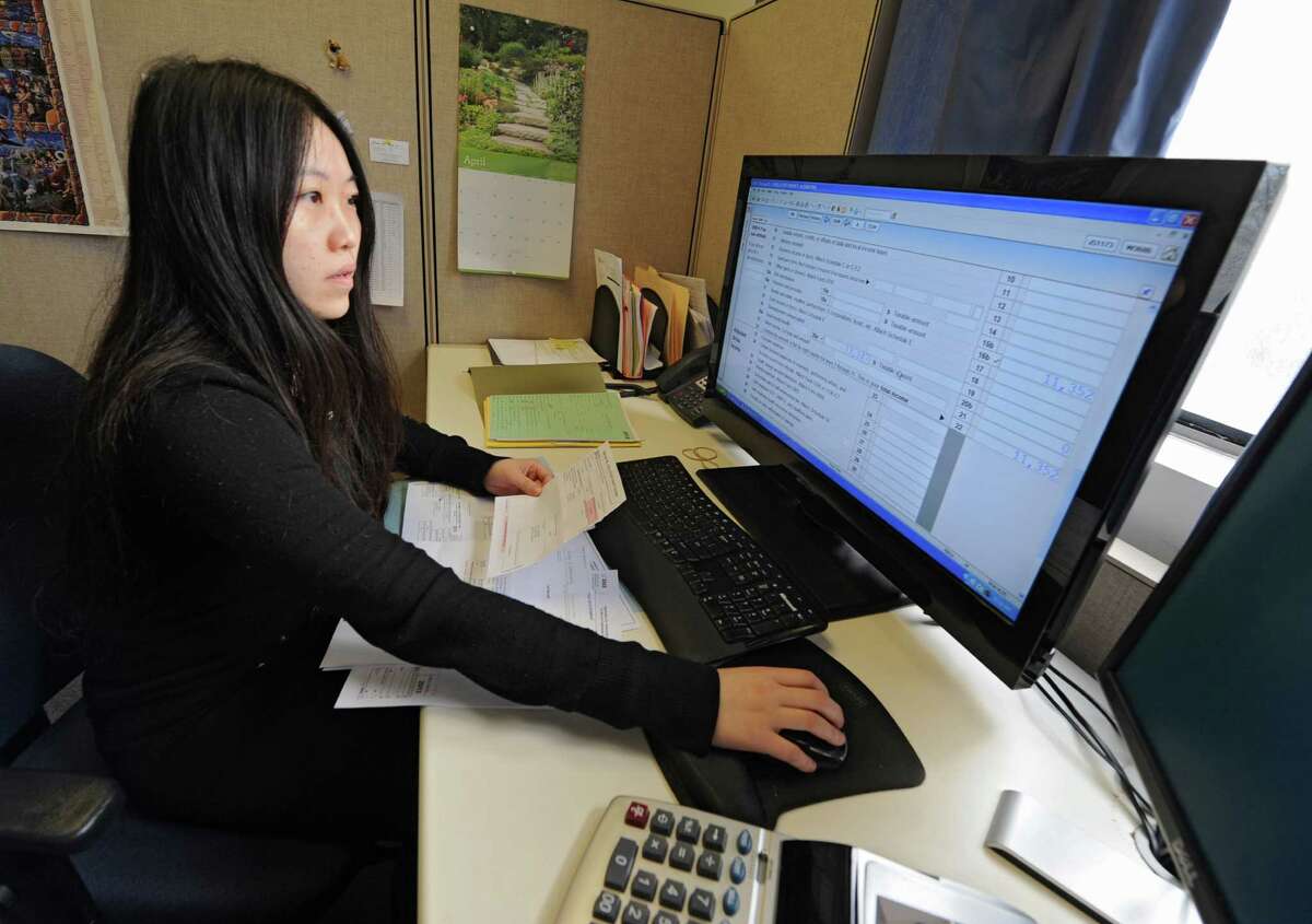 Employee Ying Xu, a graduate of RPI, works on filing taxes for clients at Jordan & Savoy certified public accountants office on Monday, April 14, 2014 in Troy, N.Y. The dealing is tomorrow. (Lori Van Buren / Times Union)