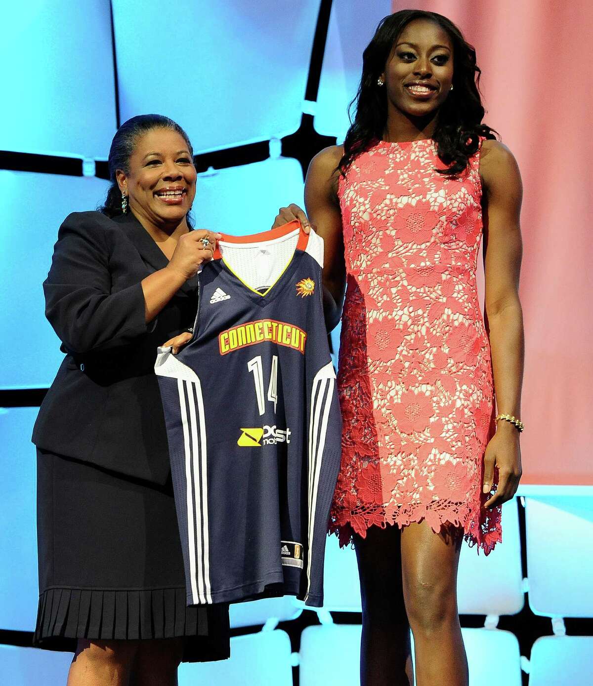 Chiney Ogwumike holds up Connecticut Sun jersey with WNBA president Laurel ...