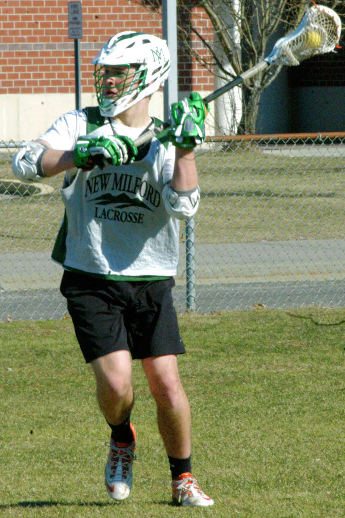 The Green Wave's Turner Ellis looks for an open teammate during a pre-season practice for New Milford High School boys' lacrosse. April 2014
