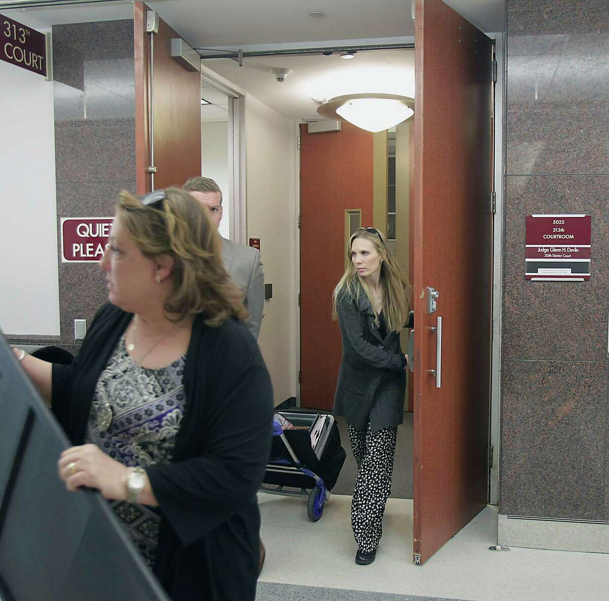 Tami Bleimeyer, right, leaves court Tuesday after a judge ruled that her six children should have no contact with her. She also testified that she is pregnant, with a baby due in August.