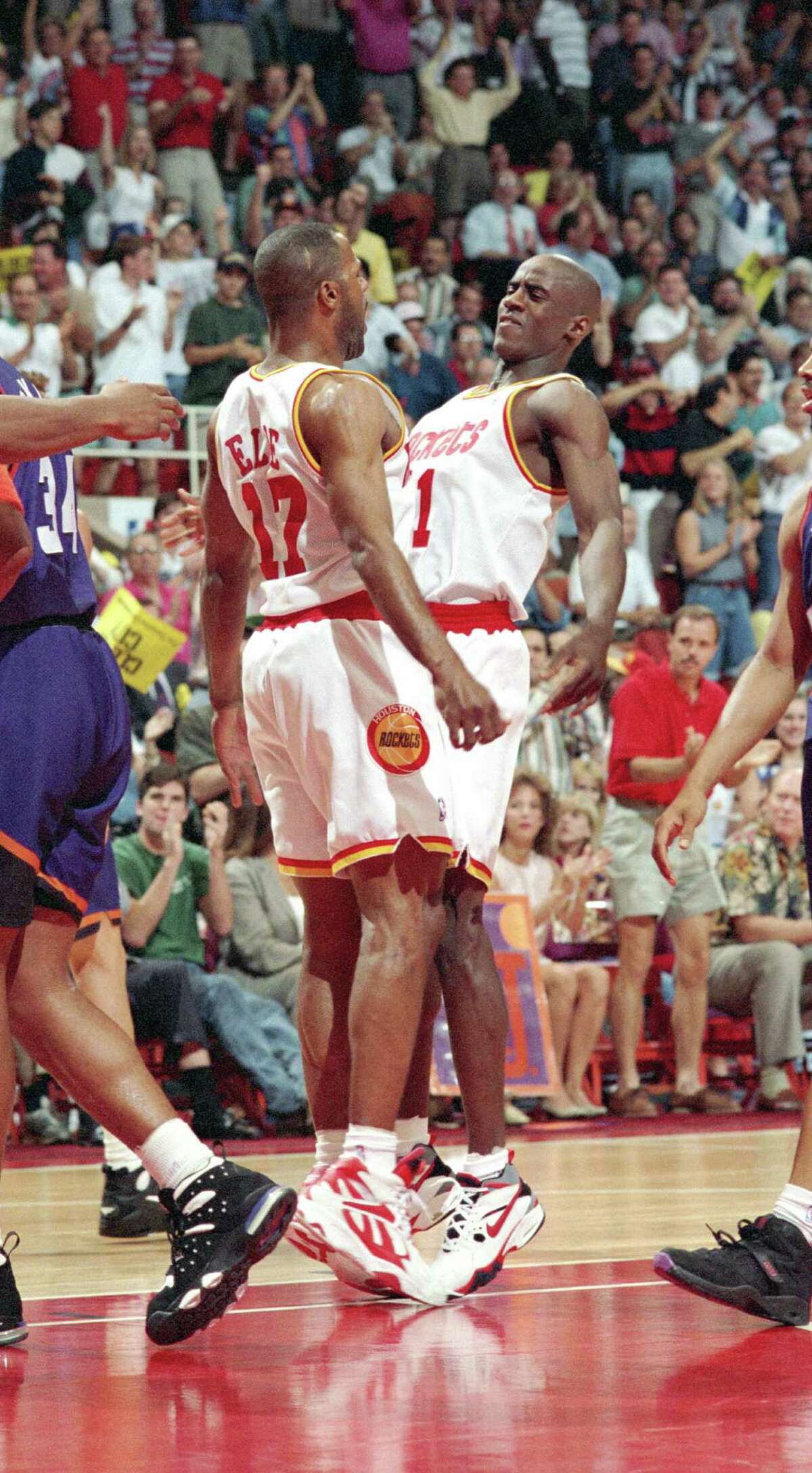 Rockets teammate Mario Elie, left, gets a taste of the fire with which Vernon Maxwell played.