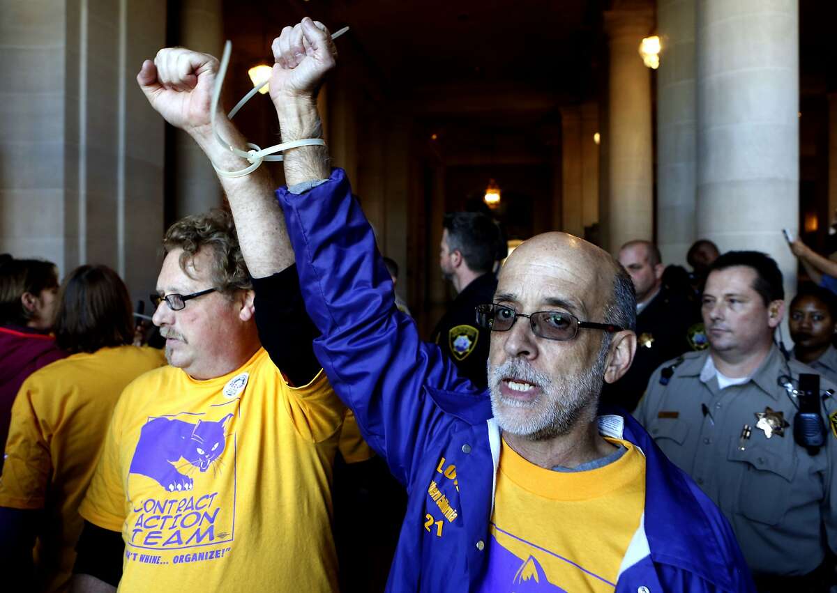 Paul Little, (left) and Larry Bradshaw were among twenty five people detained for failure to disperse from the lobby of City Hall, as union workers and supporters rallied outside on Tuesday April 15, 2014, in San Francisco, Calif. City nurses, janitors and other workers rally in front of city hall to protest the tax breaks that that local high-tech companies are receiving as they move into the Market Street area.