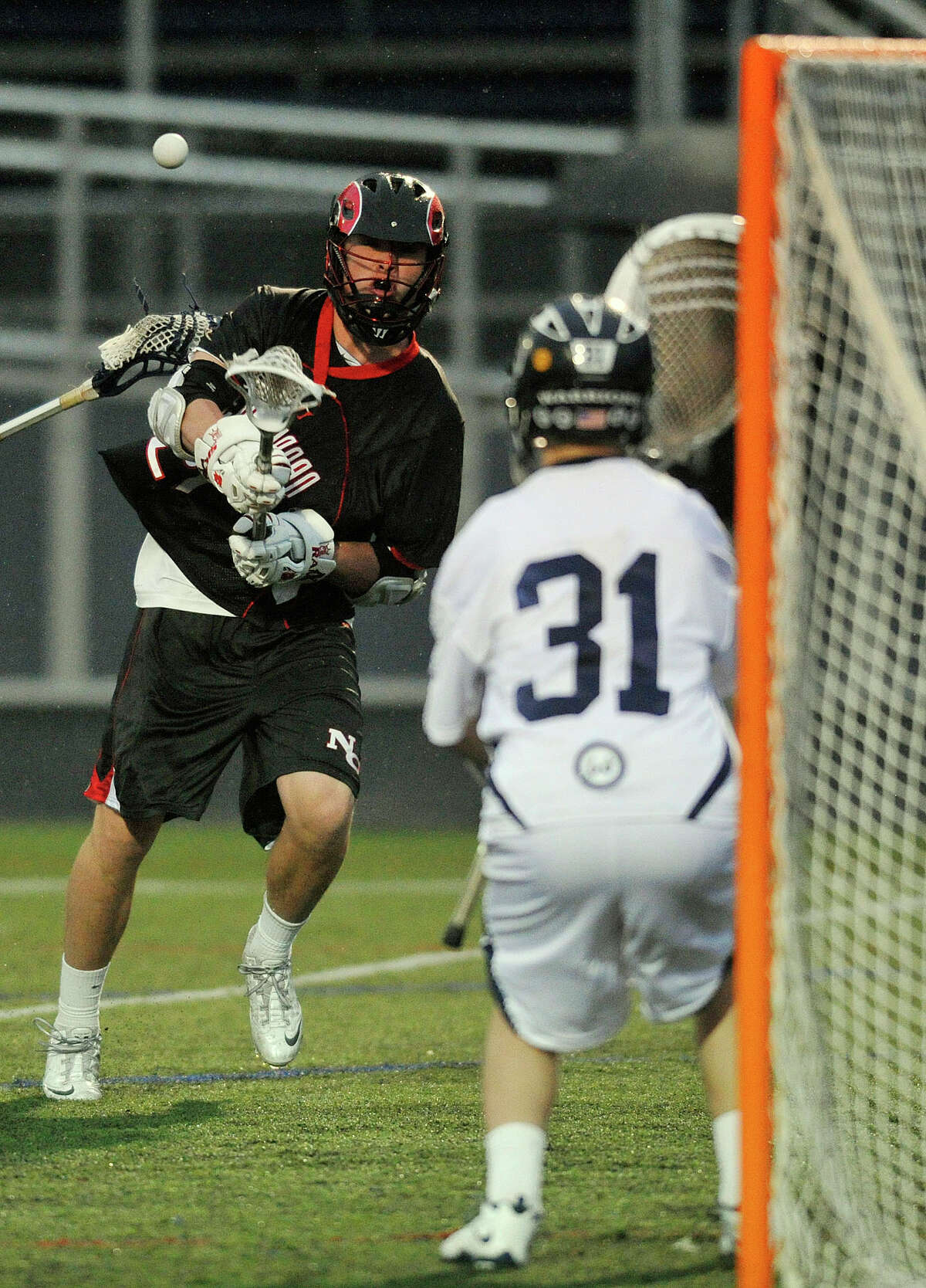New Canaan's Kyle Smith shoots on Wilton goalie Joshua Worley during their lacrosse game at Wilton High School in Wilton, Conn., on Tuesday, April 15, 2014.