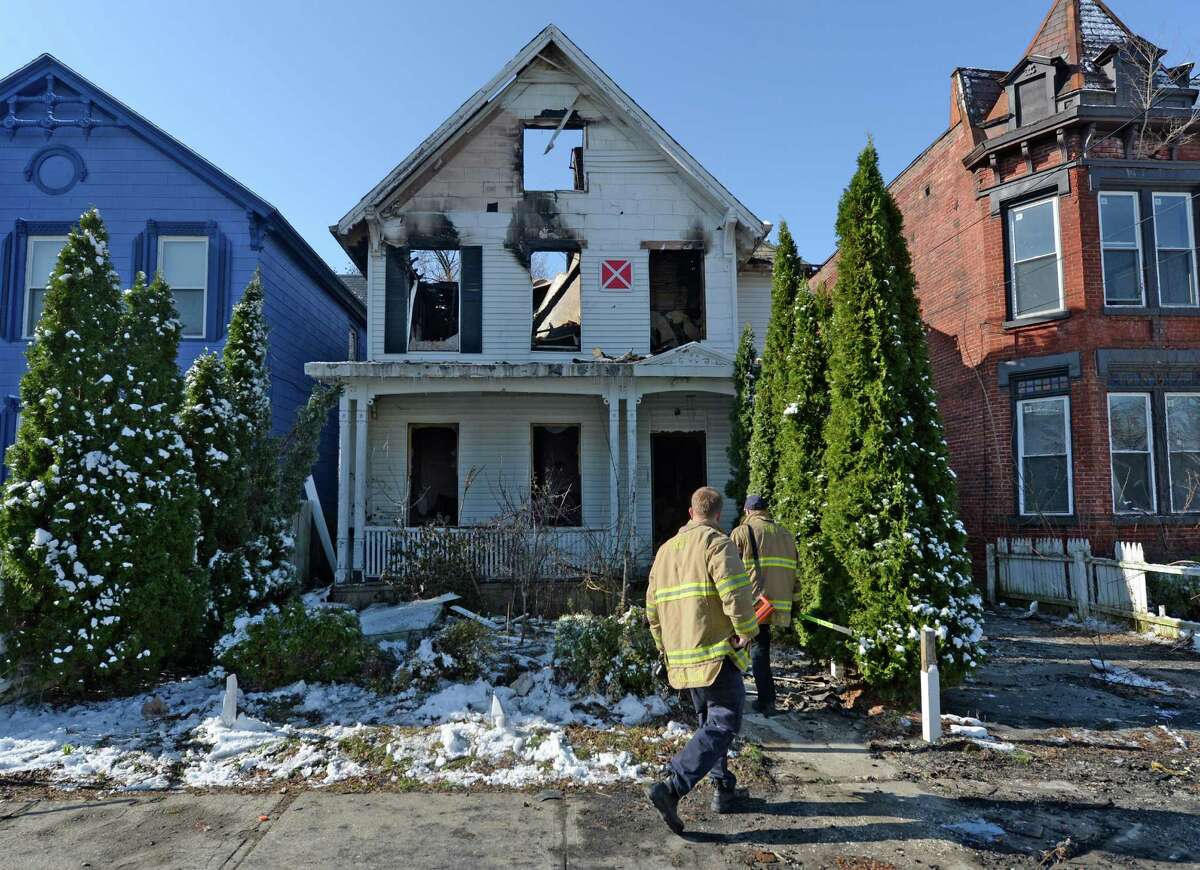 Troy firefighters inspect the remains of a home at 44 Glen Avenue Wednesday morning, April 16, 2014, after an overnight fire destroy the structure in Troy, N.Y. (Skip Dickstein / Times Union)
