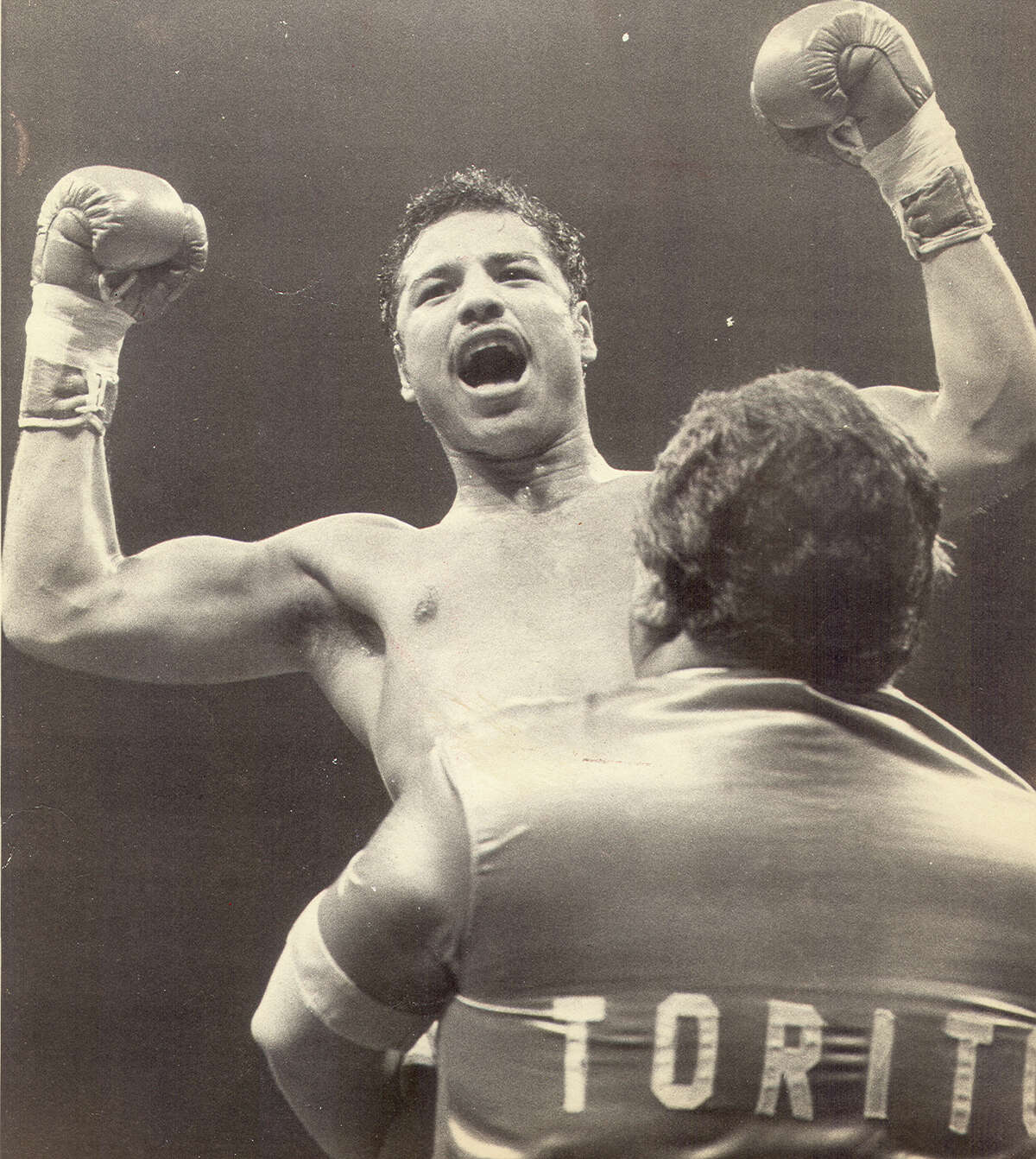 Tony Ayala Jr. is lifted up by his father Tony Ayala Sr. after a 1982 fight.