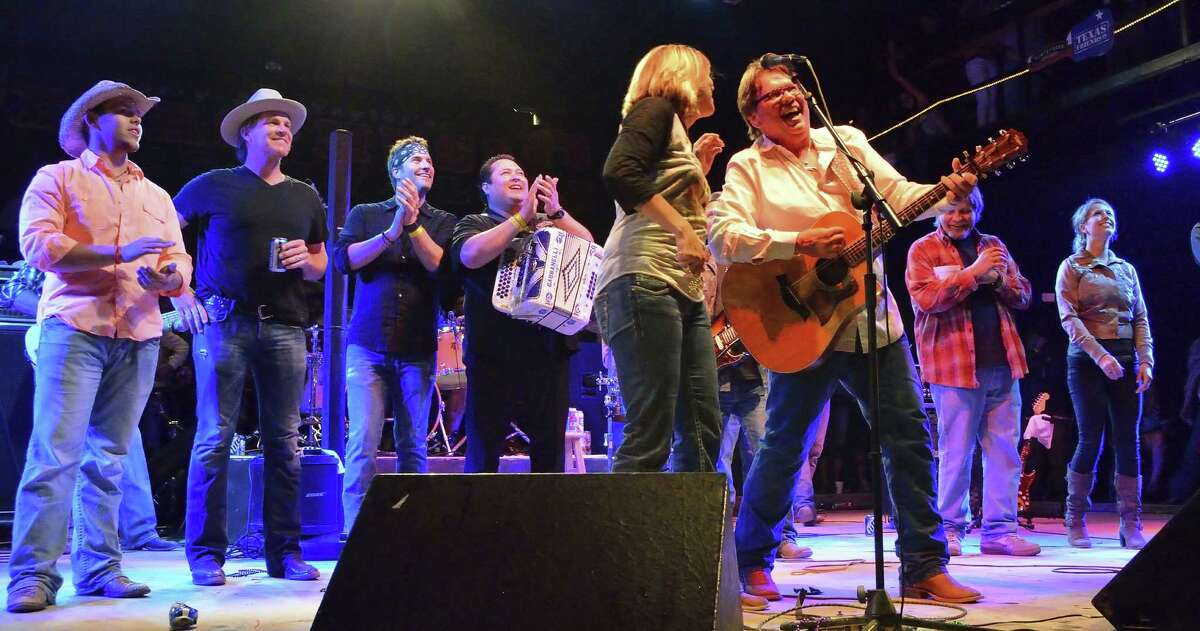 Larry Joe Taylor is joined onstage by a roster of musicians and fans at one of his Texas Music Festivals.