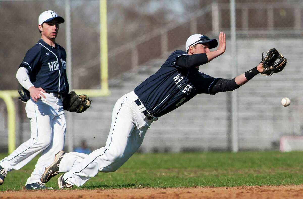 Staples high school shortstop Sam Ellinwood dives for a infield flyball during a boy's baseball game against Brien McMahon high school played at Brien McMahon high school, Norwalk, CT on Wednesday, April, 16th, 2014.